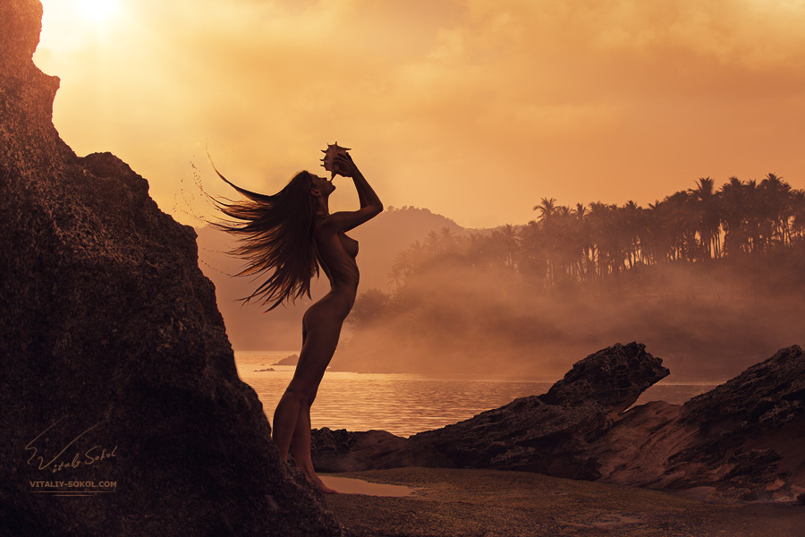 Mermaid playing seashell on sunrise beach