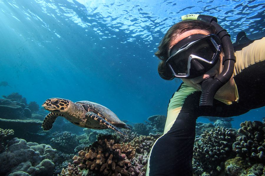 Freediver and sea turtle underwater selfie by Vitaly Sokol